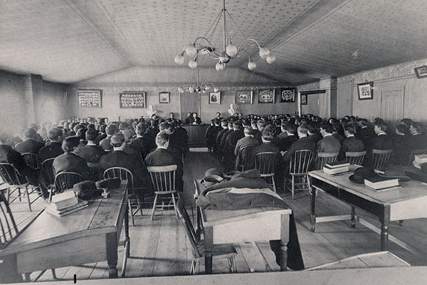 Georg Sverdrup and Sven Oftedal, speak at a gathering of students in the first Old Main building 1897.